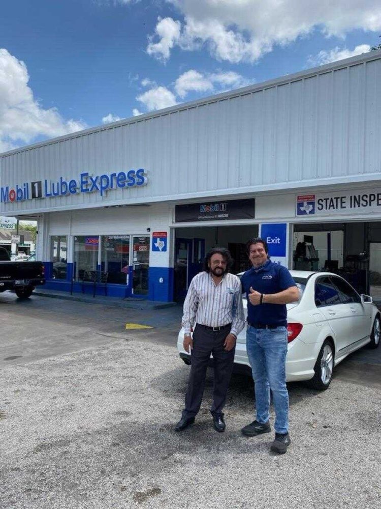 A customer outside Frankie's beneath the official Texas State Inspection sign