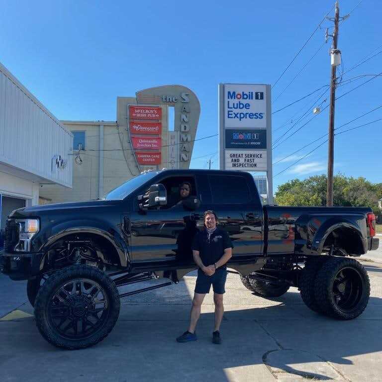 A lifted black Ford Super Duty parked at Frankie's on Richmond Avenue
